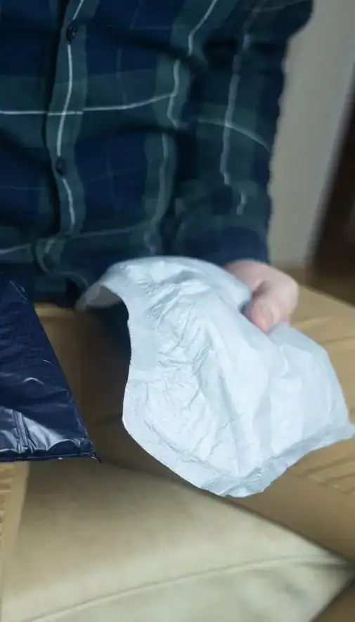 Image of man holding incontinence pads as part of overactive bladder treatment Brighton & Hove