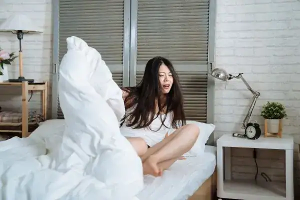 Image of woman getting up because of nighttime leaks Brighton & Hove